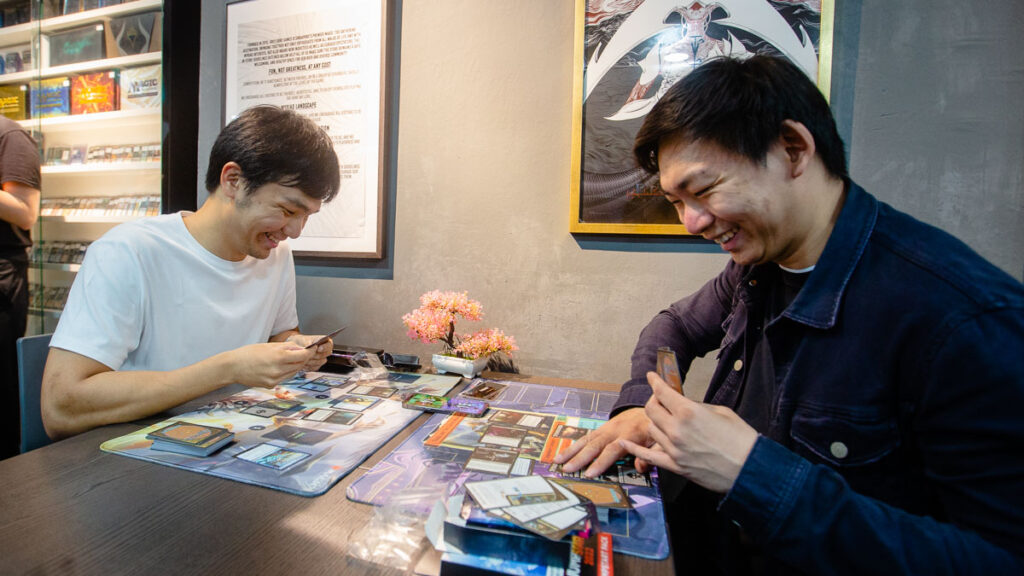 New MTG players having fun and picking up the game at Grey Ogre Games Singapore during the March of the Machine Carnival.
